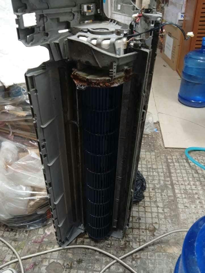 The indoor unit of a split-type aircon, taken apart, with dirt and rust on the blower wheel